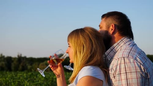 Romantic Couple Embracing in Scenic Field at Sunset