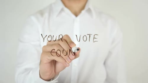 Man Writes 'Your Vote Counts' on Glass Surface