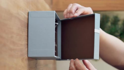 Close up of hands open elegant gift box cover