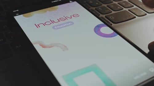 Smartphone Showing Education App on Laptop Close Up