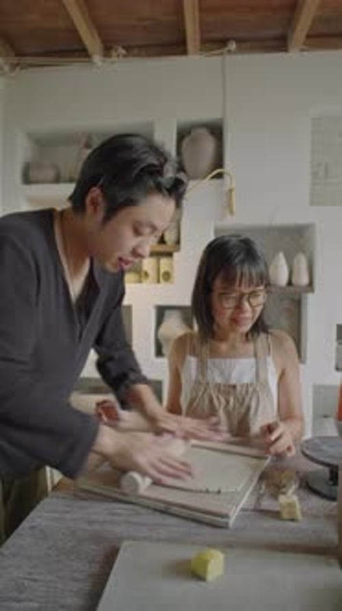 Young Adult and Child Crafting with Clay