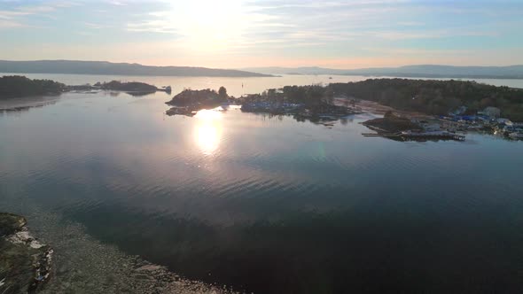 Sunset on horizon Hovedøya island Hovedoya Aker Brygge Lindøya aerial ...