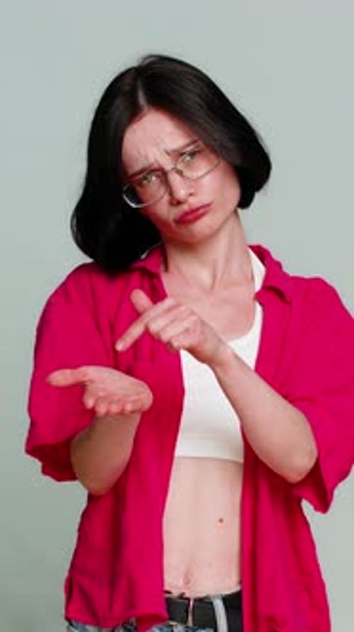 Annoyed woman gesturing and making skeptical facial expressions