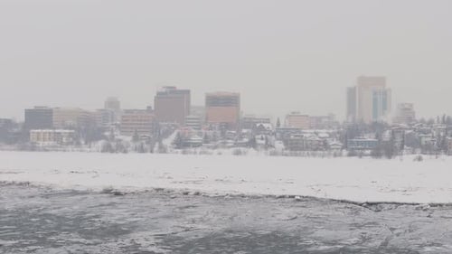 Residential buildings in Anchorage Alaska with cloudy snowy weather