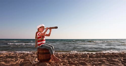 Child Sailor Looking Through Telescope on Beach