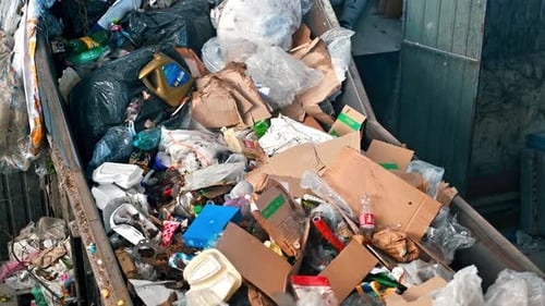 Garbage moving on a conveyor belt at waste sorting plant. Slow motion