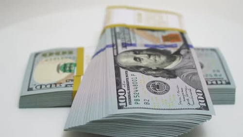 Stack of Bank Bundles with US Dollars on a White Background Closeup Shot of New Freshly Printed