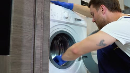 Man Cleaning the Inside of a Washing Machine