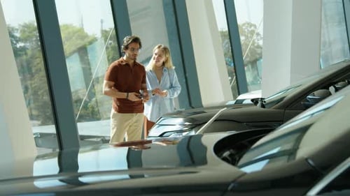 Man And Woman Looking For New Car To Buy