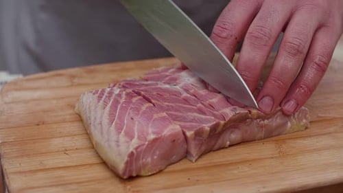 Cutting Cured Meat on a Wooden Board