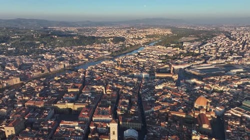 Aerial drone view over Florence cityscape and Duomo at sunrise golden hour
