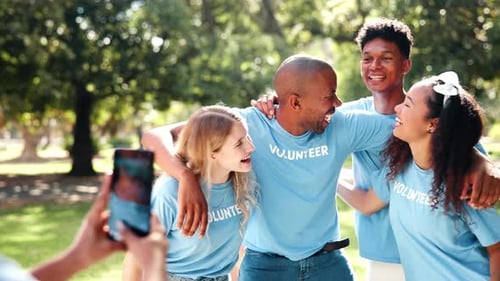 Happy Volunteers Pose Together for Photo in Park