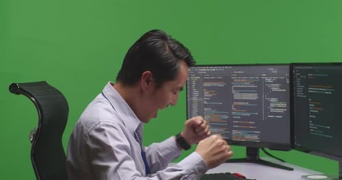 Close Up Developer Celebrating And Dancing While Write Code With Multiple Screens In Green Screen