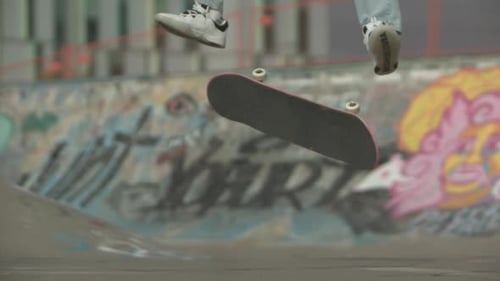 Skateboarder Does a Trick in Skate Park