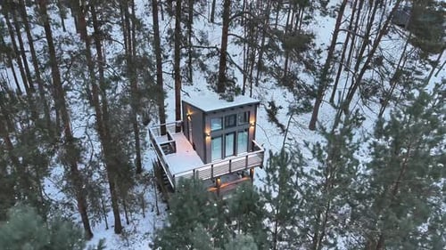 Snow covered cabin among pine forest Tervete Latvia
