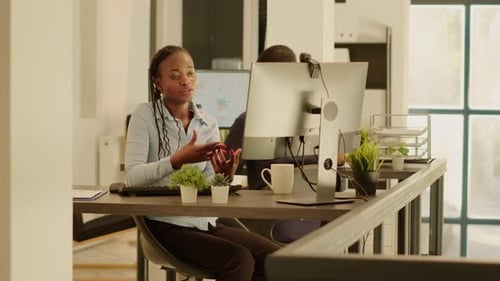 Business Woman Talking on Computer in Modern Office
