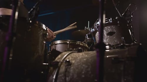 A Young Caucasian Man Drummer Plays a Drum Kit in a Music Studio