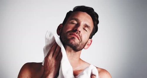 Man Dries Face With White Towel, Close Up