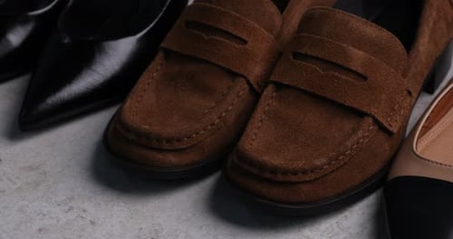 Elegant variety of shoes on concrete floor