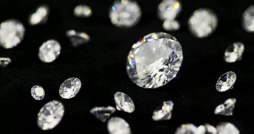 Brilliant Cut Diamonds Glimmering on Black Surface