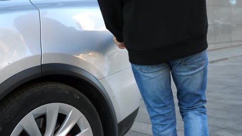 Man Gets Out Power Cord From His Electrical Auto After Charges Batteries Male Hand Plugging Out a