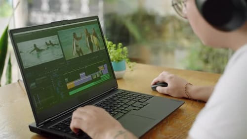 Transgender Editor Working on Video Montage at Laptop in Coworking Space Creative Pro Edits Film