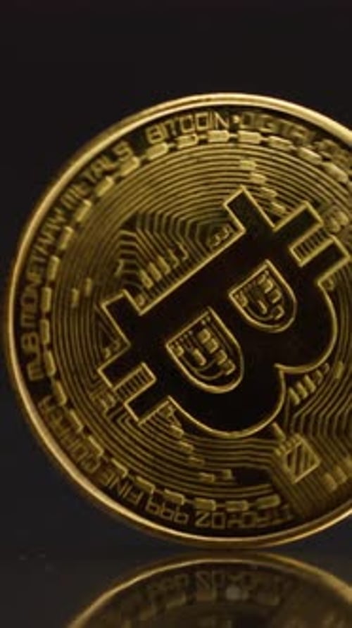 Golden Bitcoin Spinning On Black Background