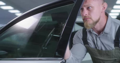 Buy car, man driver sit happy in new vehicle in dealership.