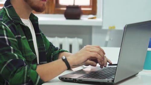 Man Working on Laptop in Modern Office