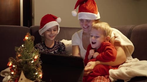 Family Watching Tablet At Christmas Time