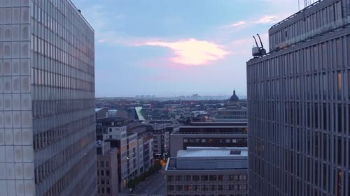Slow swish pan with drone of apartment buildings in i big city at sunset.