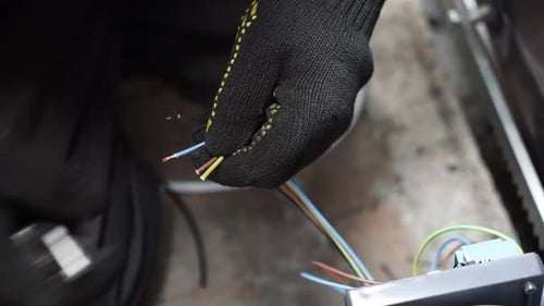Hands Stripping Wires with Utility Knife