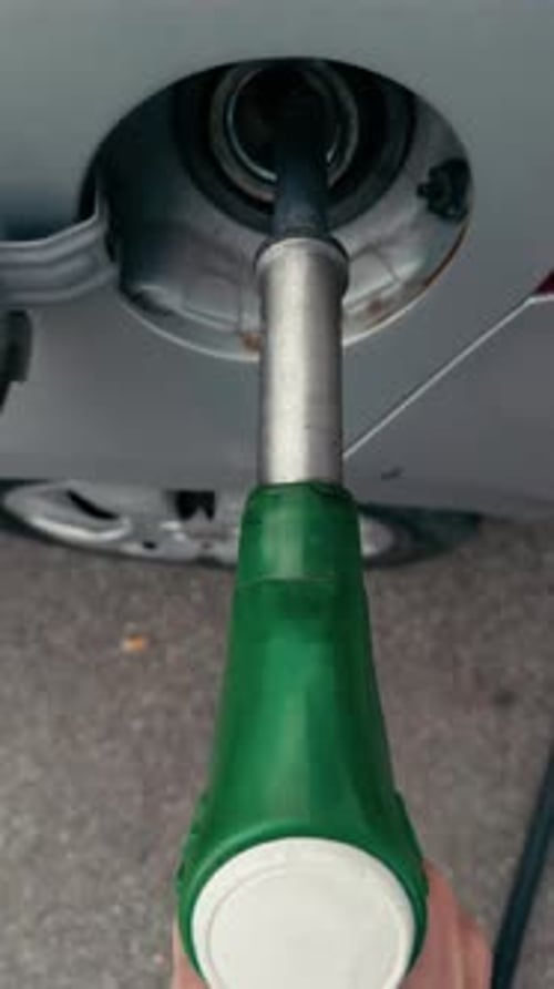 Filling Car with Green Gas Pump at Station