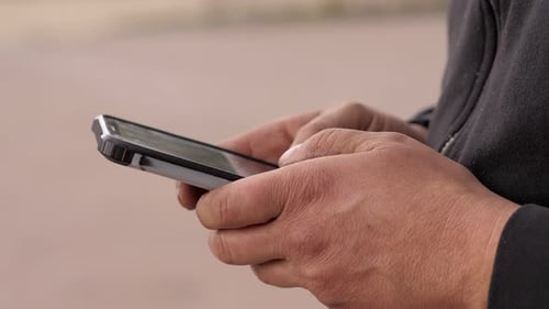 Hands Using a Mobile Phone Device