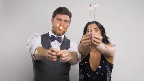 Cheerful Couple Celebrating with Sparklers and Dancing