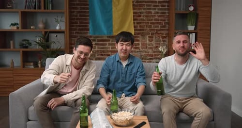 Men Watching TV with Beer and Popcorn