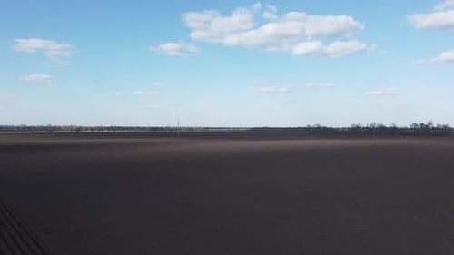 Tractor with yellow seeder working on the field in Ukraine OA Lexa