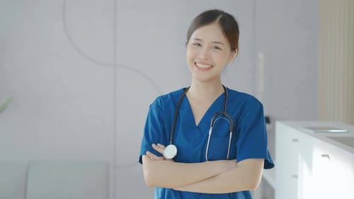 Smiling Young Adult Woman in Blue Scrubs