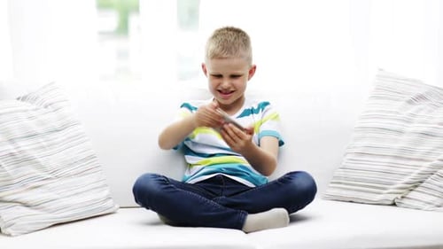 Boy Enjoys Playing Video Game on Smartphone