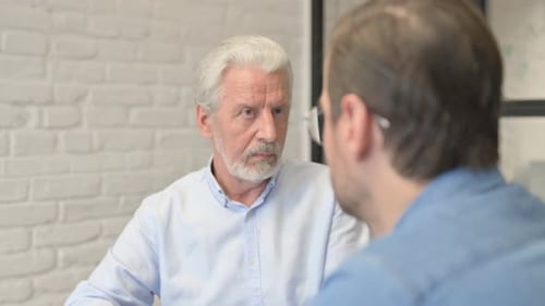 Close up of Old Businessman Talking with Employee in Office
