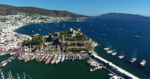 Aerial view of Bodrum marina and Bodrum castle. White painted houses. 4K