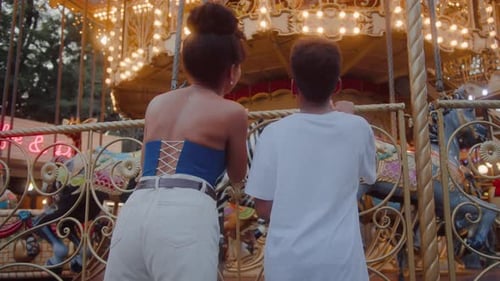 Woman and Child Watch Merry-Go-Round