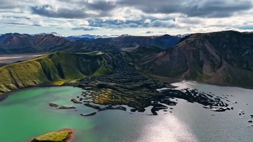 Drone Flyover Capturing Lava Flowing Into a Turquoise Lake from Above