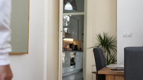 Young tall man goes through room and feels sudden severe pain in anus area, clutches his buttocks. W