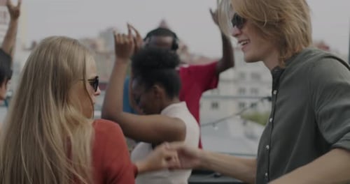 Friends Dancing and Celebrating at Rooftop Party