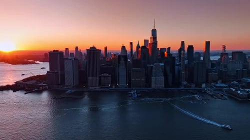 Architecture of Manhattan in the orange rays of setting sun.