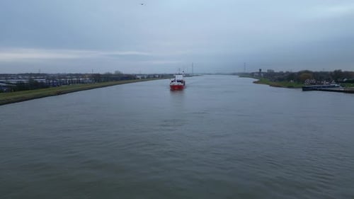 Flying Towards The Cargo Ship Traveling Across The River Near Dordrecht, Netherlands. Aerial Drone S