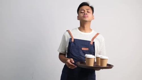 Young Man Holding Tray of Coffee in Studio