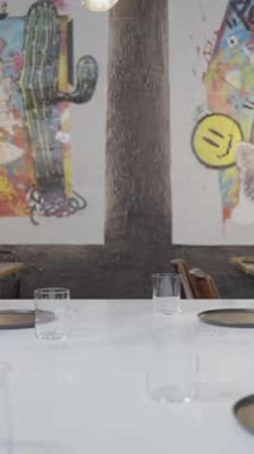 Push Out Along Set Table with No People and Art on Wall in Restaurant