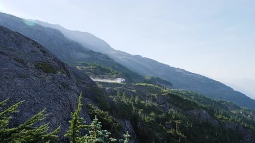 RV/Campervan driving away on scenic road in canada (salmon glacier)